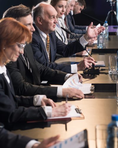 Politicians and journalists taking part in press conference